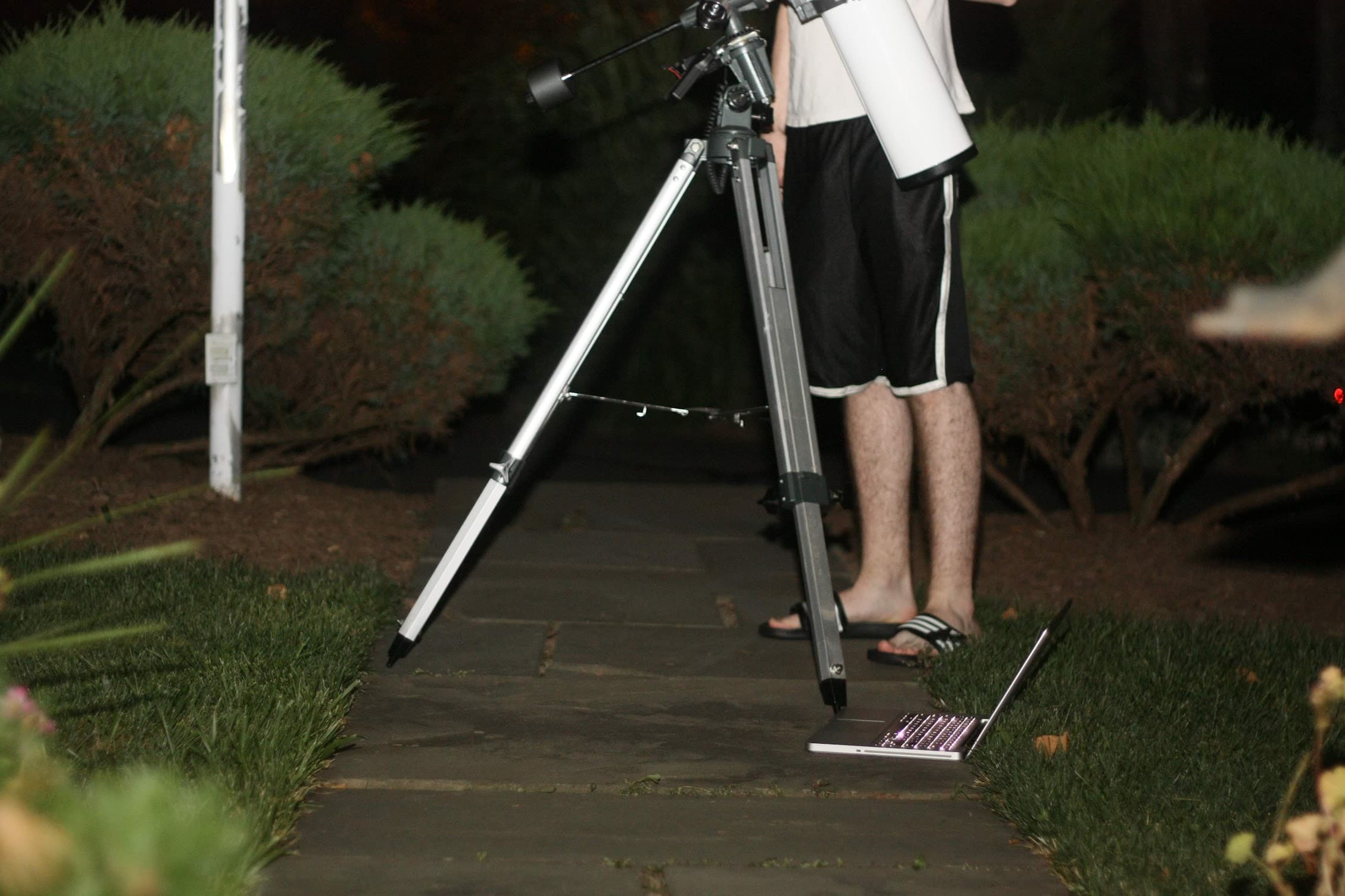 Jim Washkau using a telescope at night